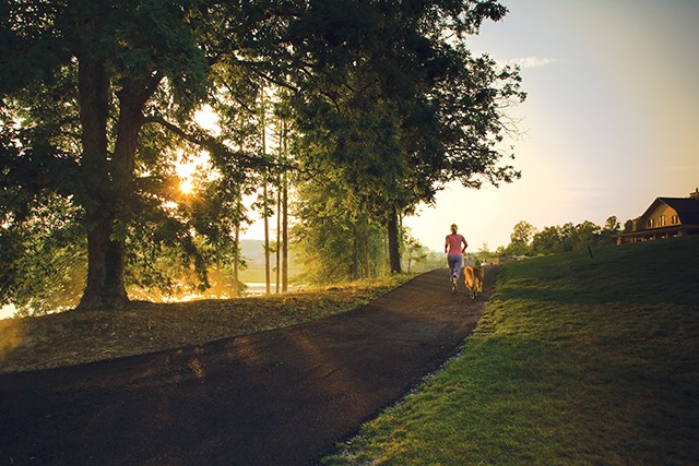 Woman jogging with her dog around the lake at Sterling on the Lake