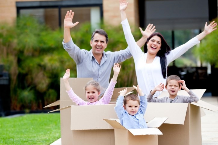 family jumping out of moving boxes at Sterling on the Lake