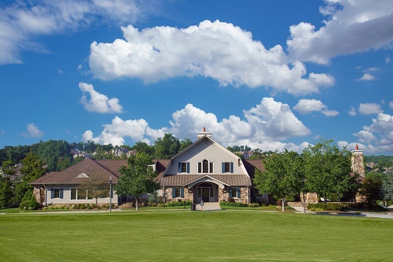 Exterior of Clubhouse and Village Green greenspace at Sterling on the Lake.